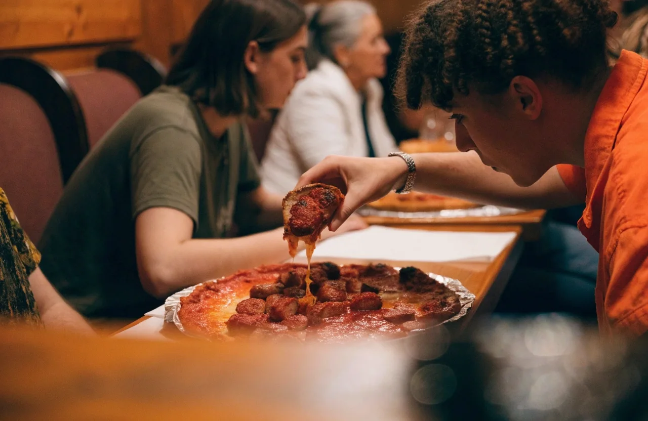 Sausage coal-fired pizza served on a restaurant table